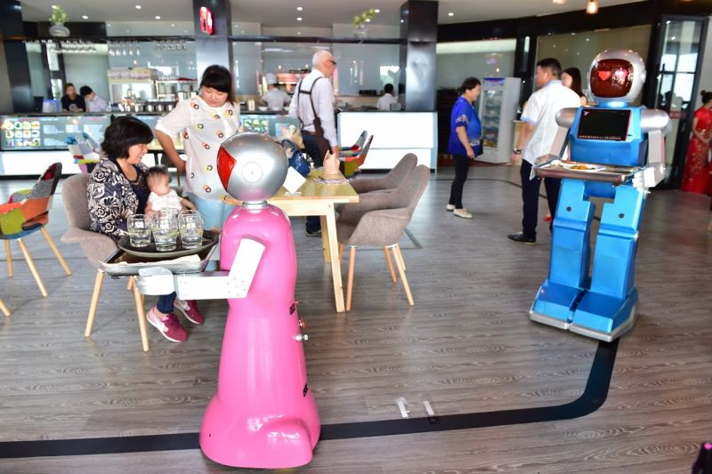 Little Blue (blue) and Little Peach (pink) at a robot restaurant in Yiwu China via Getty
